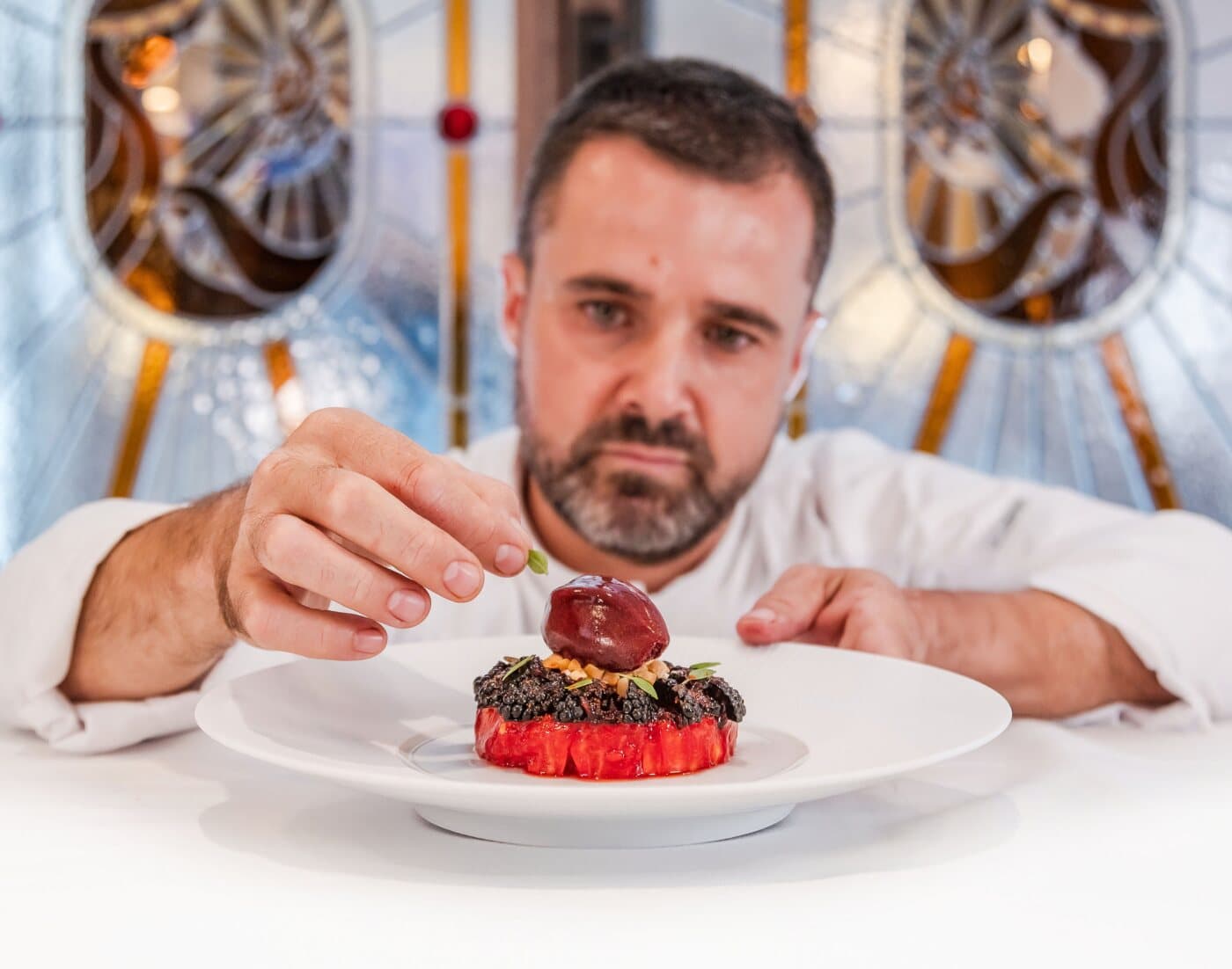 Le chef Loïc Dantec dresse un dessert à la table